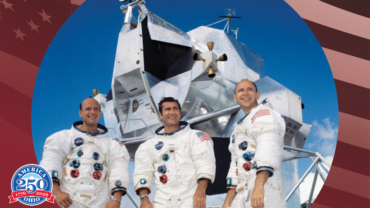 Three astronauts standing in front of Apollo 12 space craft