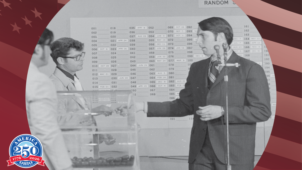 historic photo of a man at a microphone
