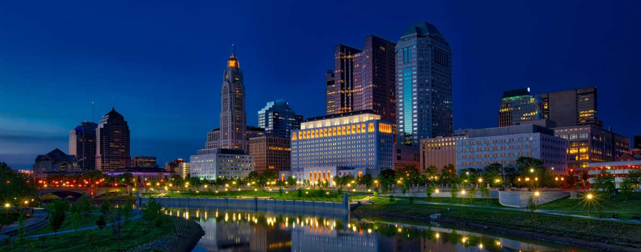 Image of the Thomas J. Moyer Ohio Judicial Center as seen from the banks of the Scioto River at night.
