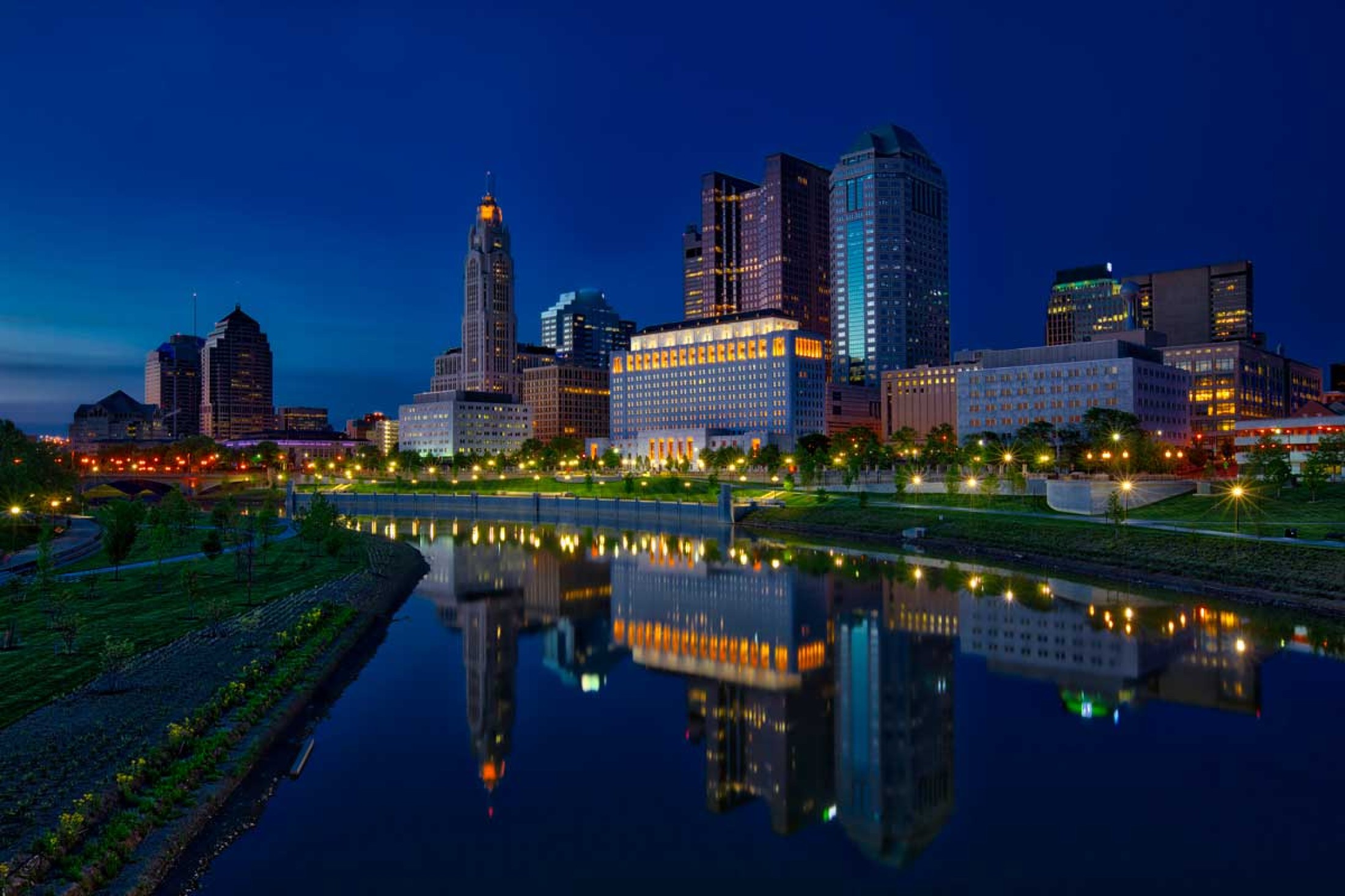 Image of the Thomas J. Moyer Ohio Judicial Center as seen from the banks of the Scioto River at night.