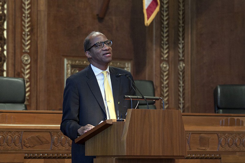 Image of Wil Haygood speaking from behind a podium in the courtroom of the Thomas J. Moyer Ohio Judicial Center