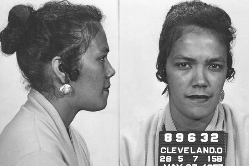 Black and white image of a police mug shot of an African American woman from the 1950s.