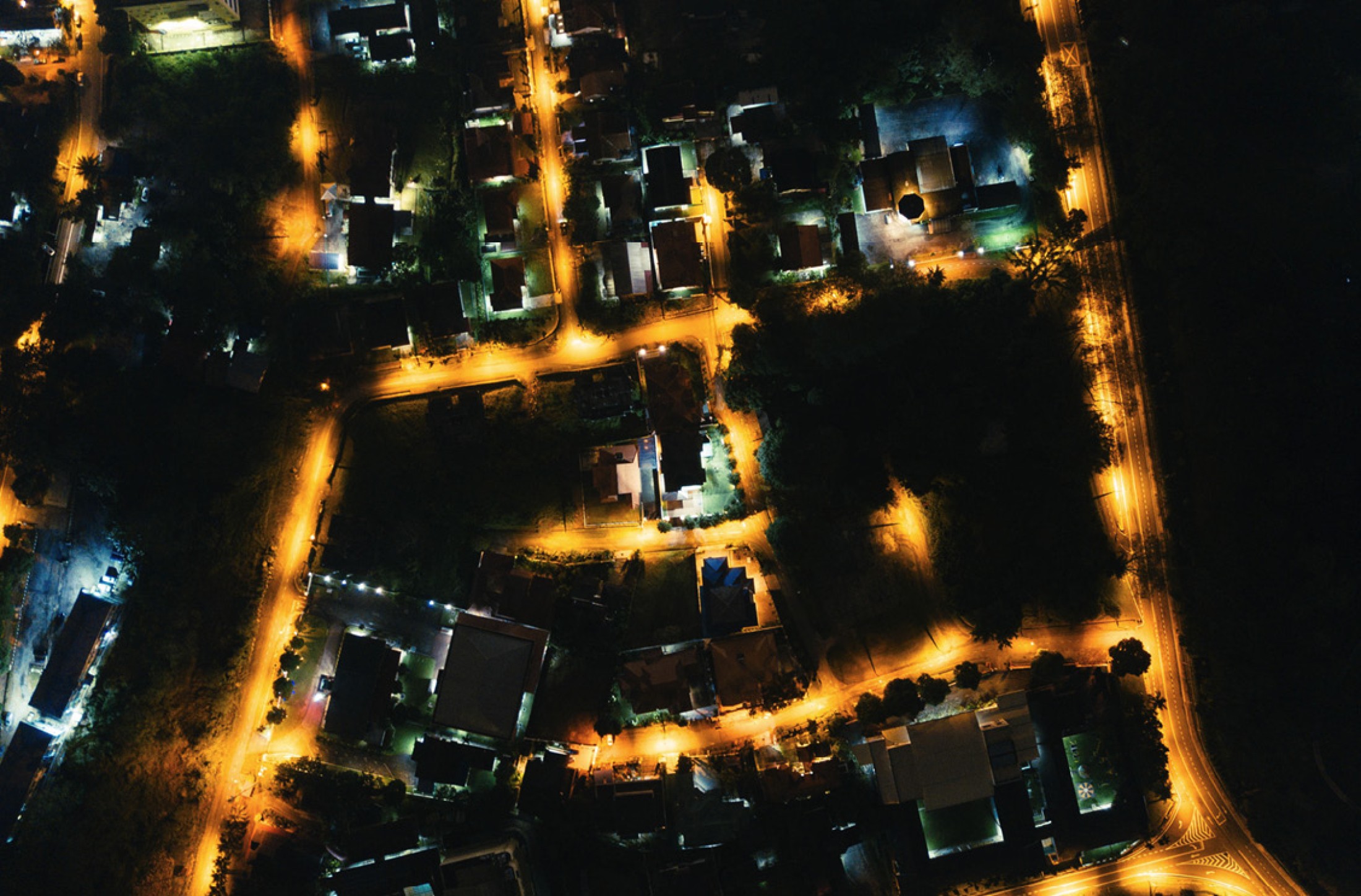 Aerial view of a Columbus neighborhood at night. The streets are glowing orange.